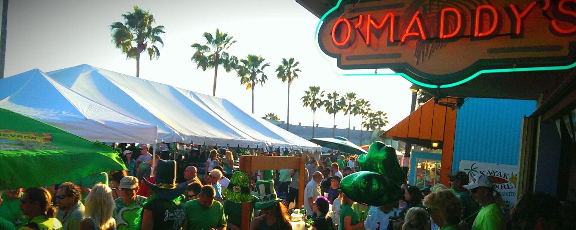 A St. Patrick's Day crowd in green gathered under the O'Maddy's neon sign