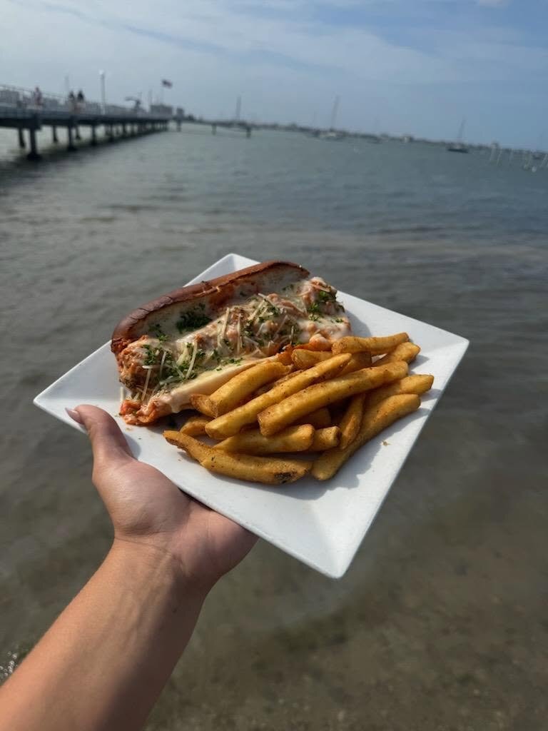 A plate held out over the bay at the Gulfport pier