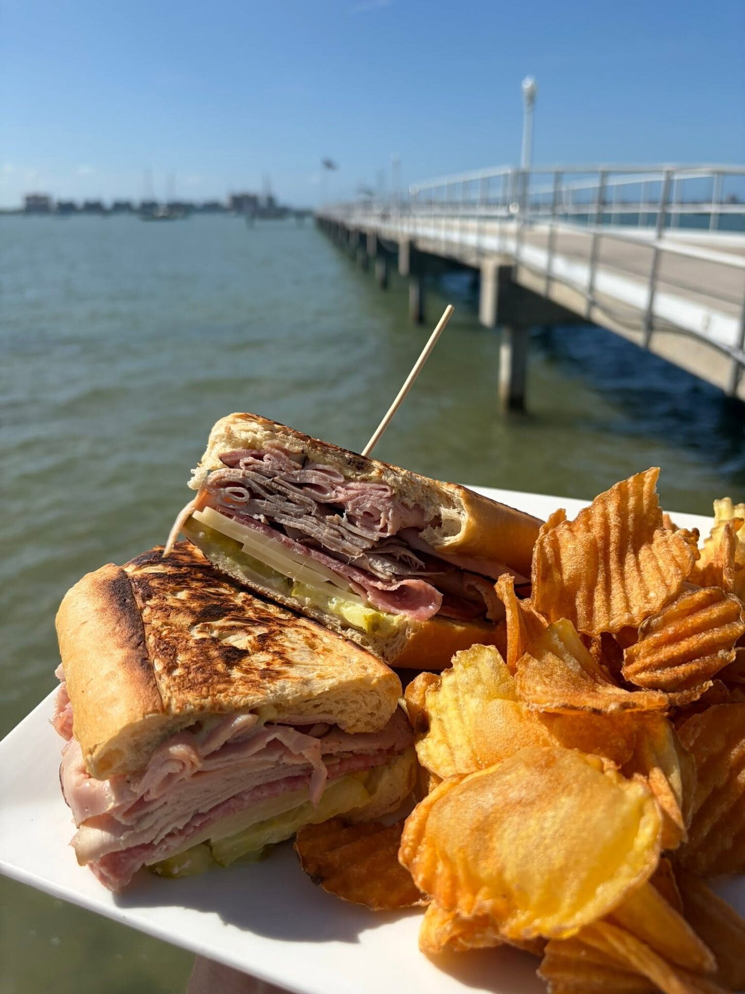 A Cuban sandwich with the Gulfport pier behind
