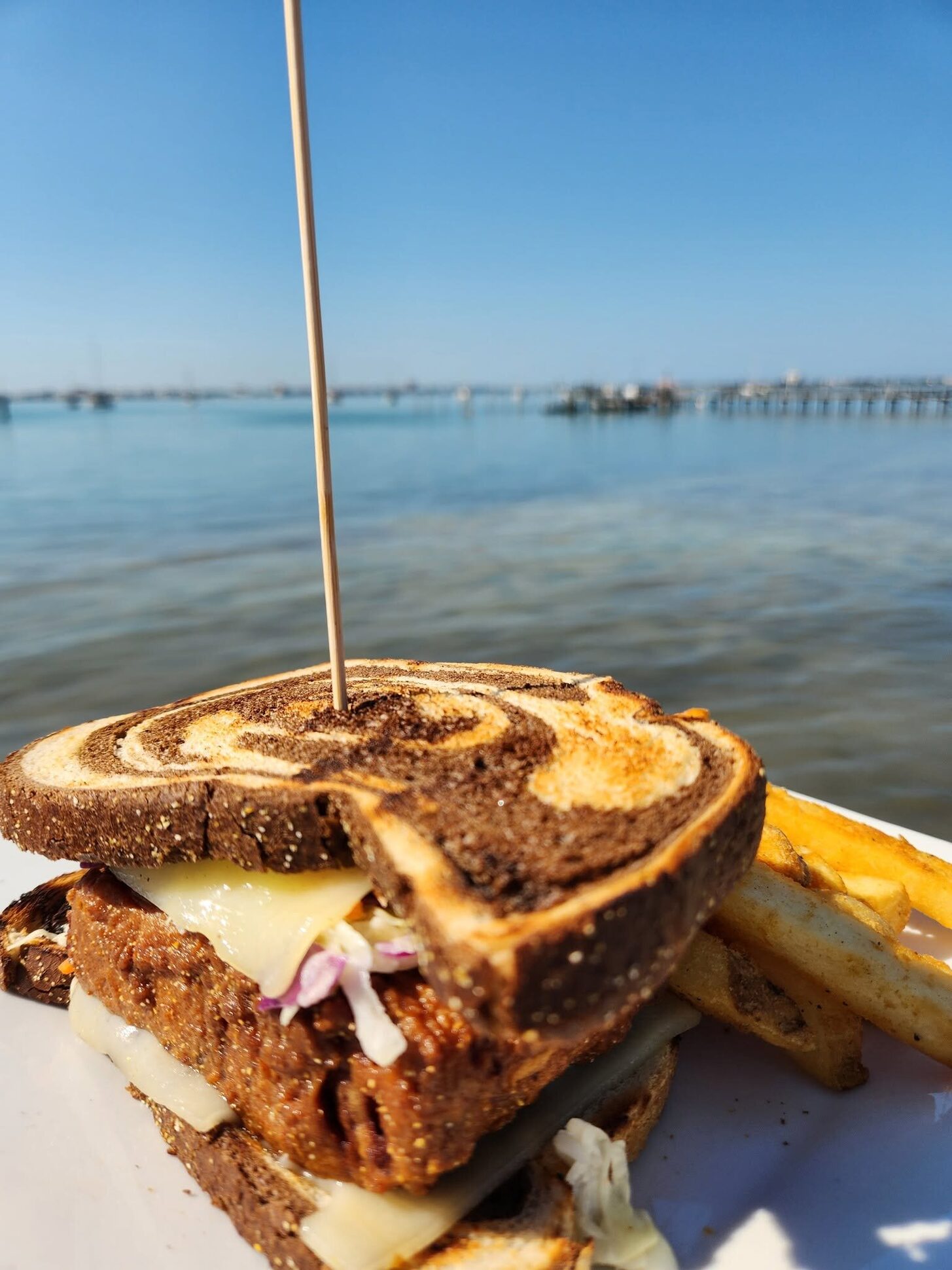 A patty melt on marble rye over the bay