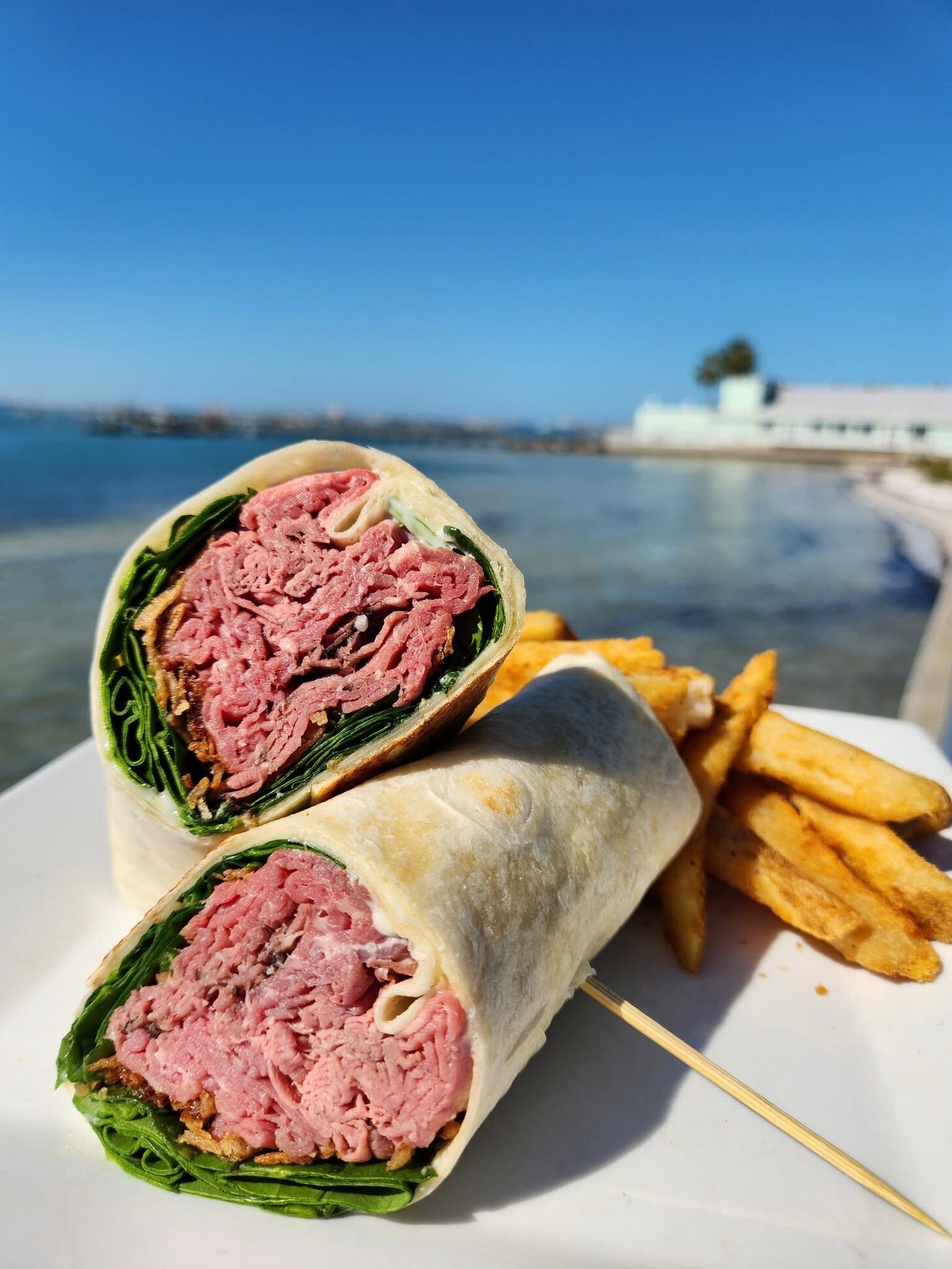 A roast-beef wrap with fries on the O'Maddy's rail against the bay
