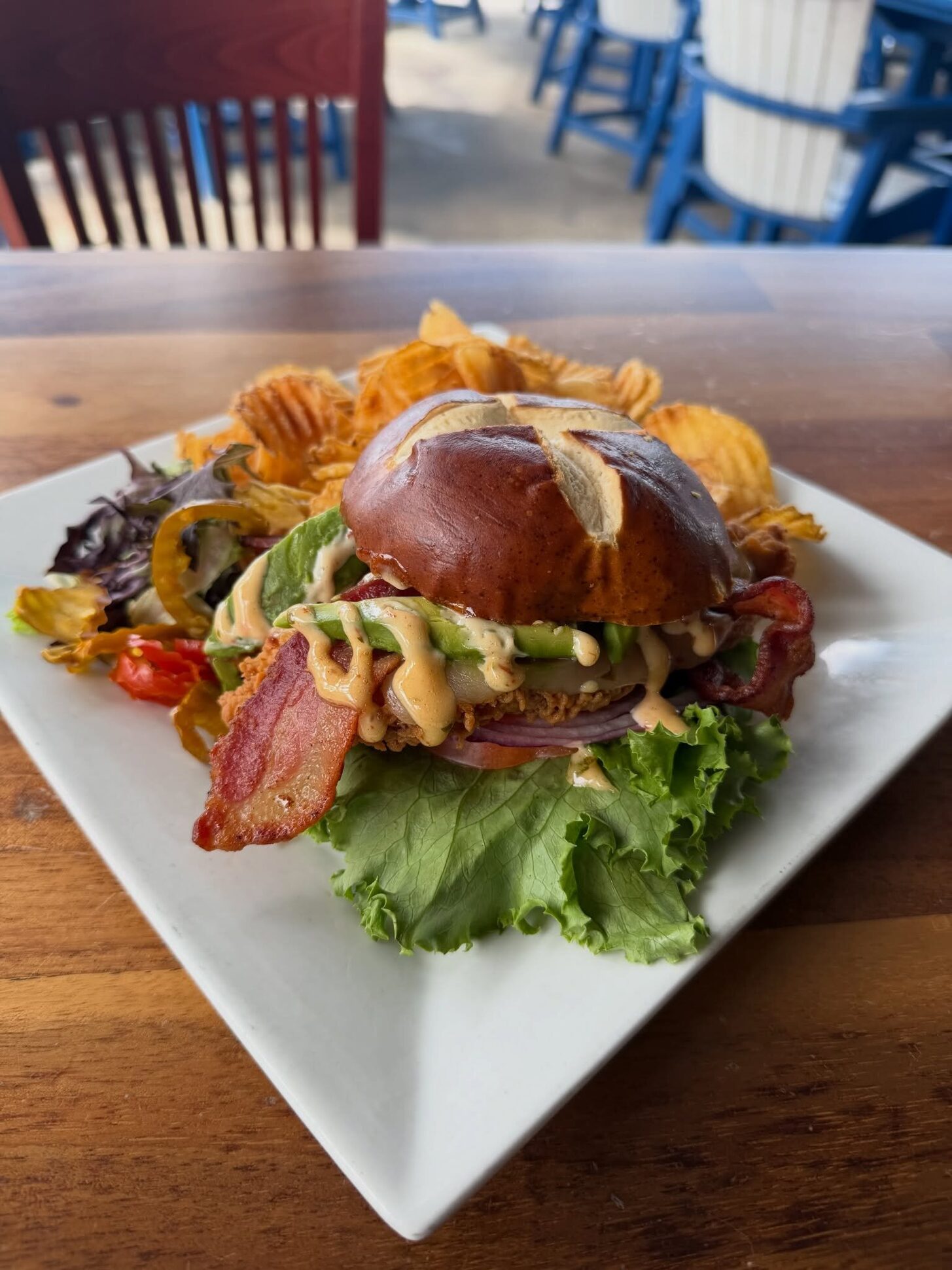 A bacon burger on a pretzel bun